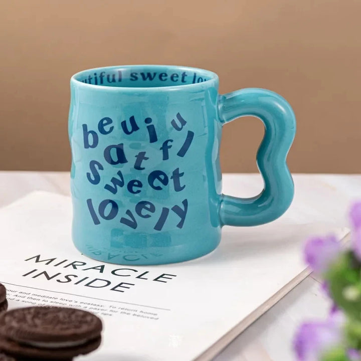 blue aesthetic wavy ceramic mugs with quirky "beautiful, sweet, lovely" text.
