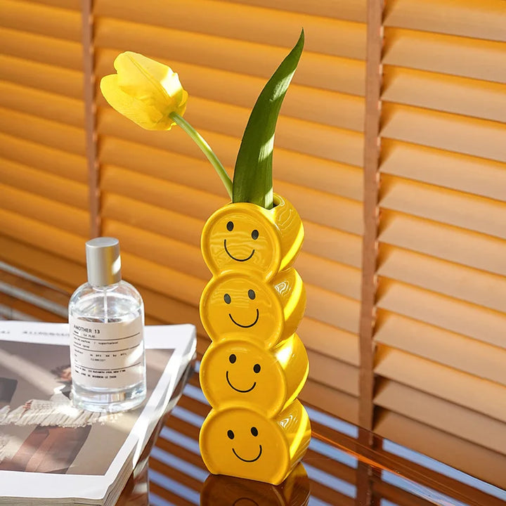 Smiley ceramic vase with fresh flowers in a cozy living room