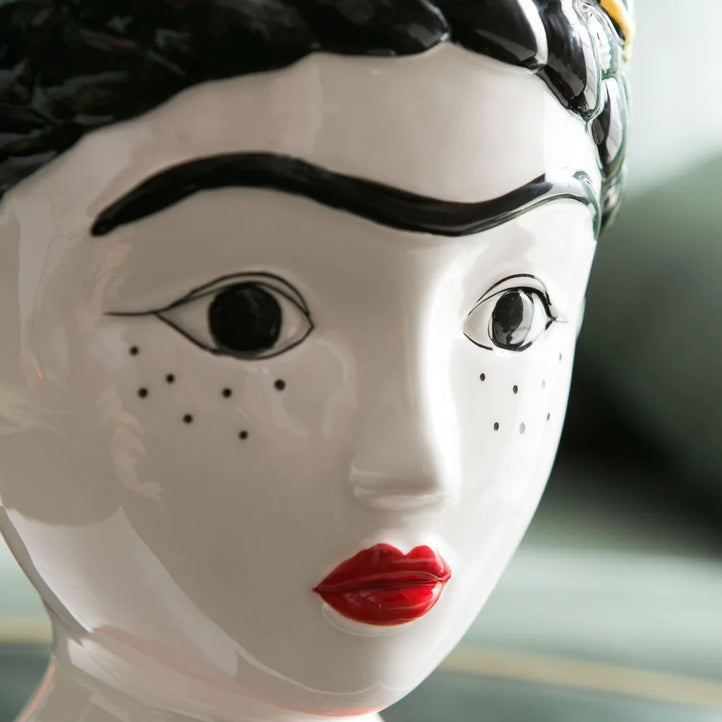 Hand-painted ceramic doll vase with floral design"