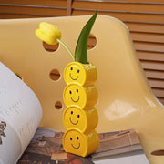 Smiley ceramic vase with fresh flowers in a cozy living room