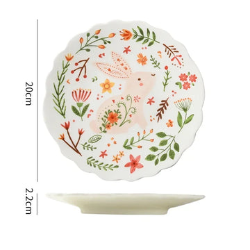Colorful floral ceramic plates stacked on a table, showcasing intricate and vibrant flower and leaf patterns