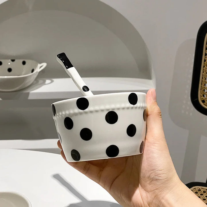 Charming polka dot ceramic dishes and cups displayed on open kitchen shelves