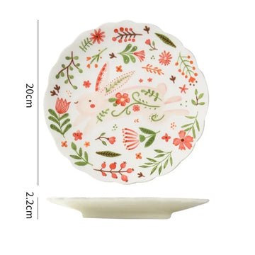 Colorful floral ceramic plates stacked on a table, showcasing intricate and vibrant flower and leaf patterns