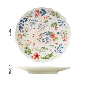 Colorful floral ceramic plates stacked on a table, showcasing intricate and vibrant flower and leaf patterns