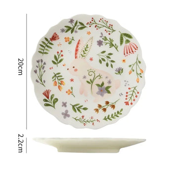 Colorful floral ceramic plates stacked on a table, showcasing intricate and vibrant flower and leaf patterns