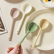 Stylish pastel ceramic spoons in green, yellow, white, and pink ready to enhance your tableware collection