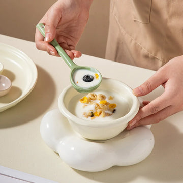 Stylish pastel ceramic spoons in green, yellow, white, and pink ready to enhance your tableware collection