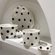 Charming polka dot ceramic dishes and cups displayed on open kitchen shelves