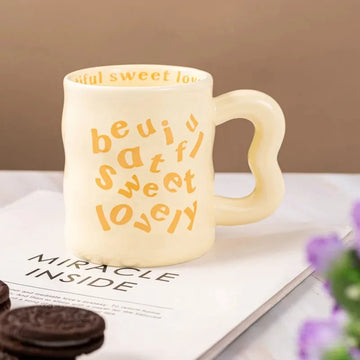 Yellow aesthetic wavy ceramic mugs with quirky "beautiful, sweet, lovely" text.