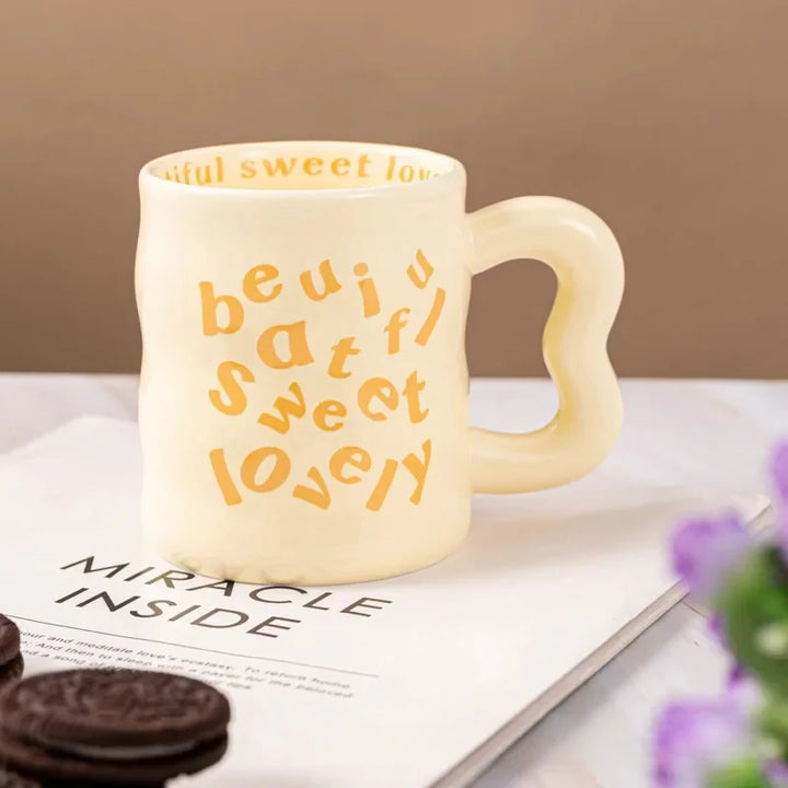 Yellow aesthetic wavy ceramic mugs with quirky "beautiful, sweet, lovely" text.