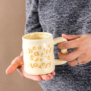 Yellow aesthetic wavy ceramic mugs with quirky "beautiful, sweet, lovely" text.