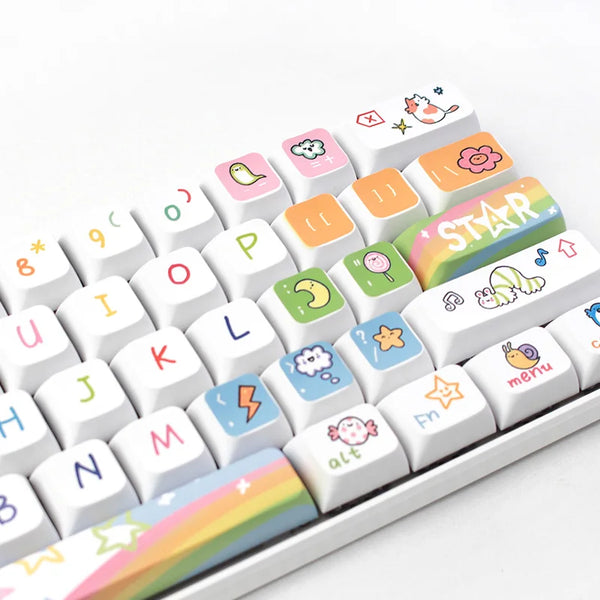 Close-up view of a white keyboard with colorful, hand-drawn Kawaii keycaps, featuring playful icons and symbols on the keys