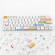 Close-up view of a white keyboard with colorful, hand-drawn Kawaii keycaps, featuring playful icons and symbols on the keys
