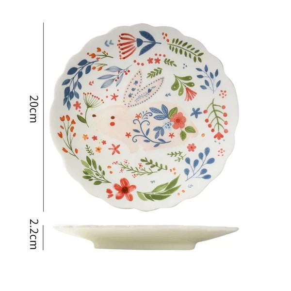 Colorful floral ceramic plates stacked on a table, showcasing intricate and vibrant flower and leaf patterns