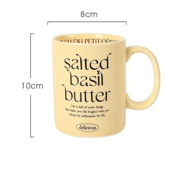 Breakfast-inspired pastel ceramic mugs with playful text designs, featuring unique flavor themes like Salted Basil Butter and Cherry Strawberry, perfect for aesthetic coffee or tea moments