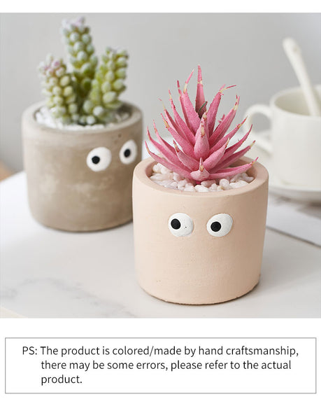cement flower pot with artificial succulents